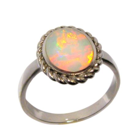Australian Solid Opal Ring mined on the opal fields of Coober Pedy Australia, has been inlaid in solid sterling silver with an open back.